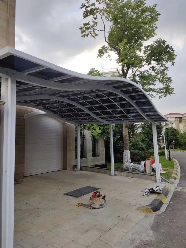 Installed curved aluminum carport beside a residential building