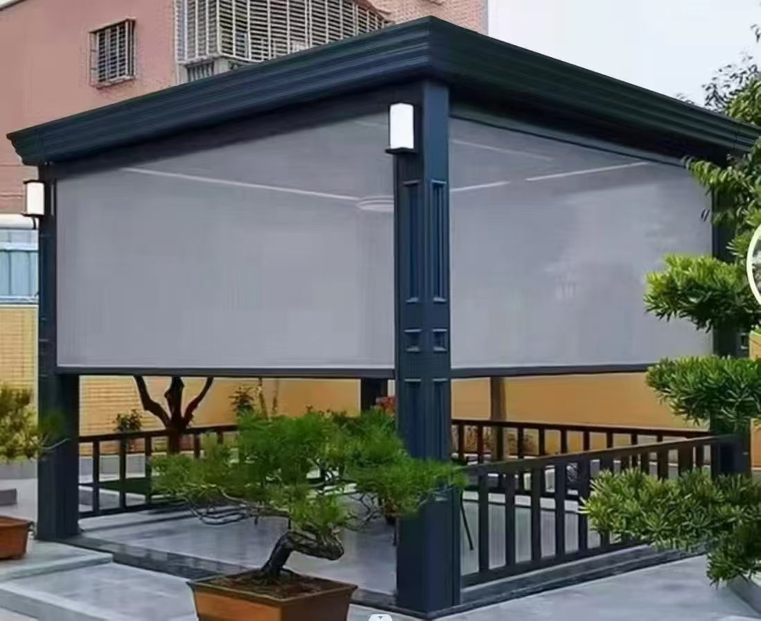 Freestanding aluminum pergola with retractable windproof roller screens installed in a residential courtyard