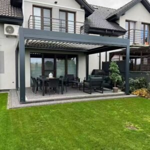 Motorized aluminum louvered pergola with adjustable roof blades installed over a residential garden patio
