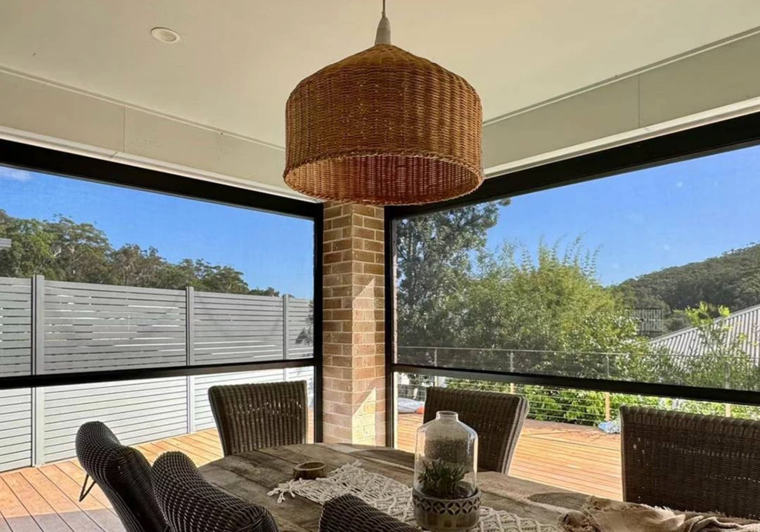 Outdoor dining patio protected by retractable zip screens