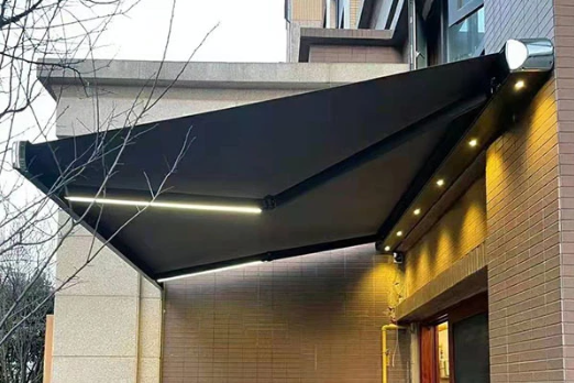 Motorized full cassette awning with integrated lighting