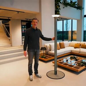 Product demonstration of a Milan patio umbrella with an aluminum center pole, integrated LED light and freestanding base