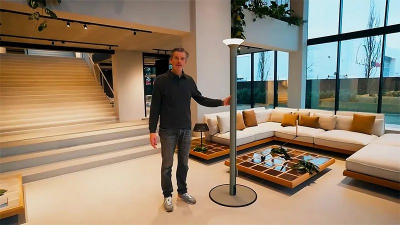 Product demonstration of a Milan patio umbrella with an aluminum center pole, integrated LED light and freestanding base