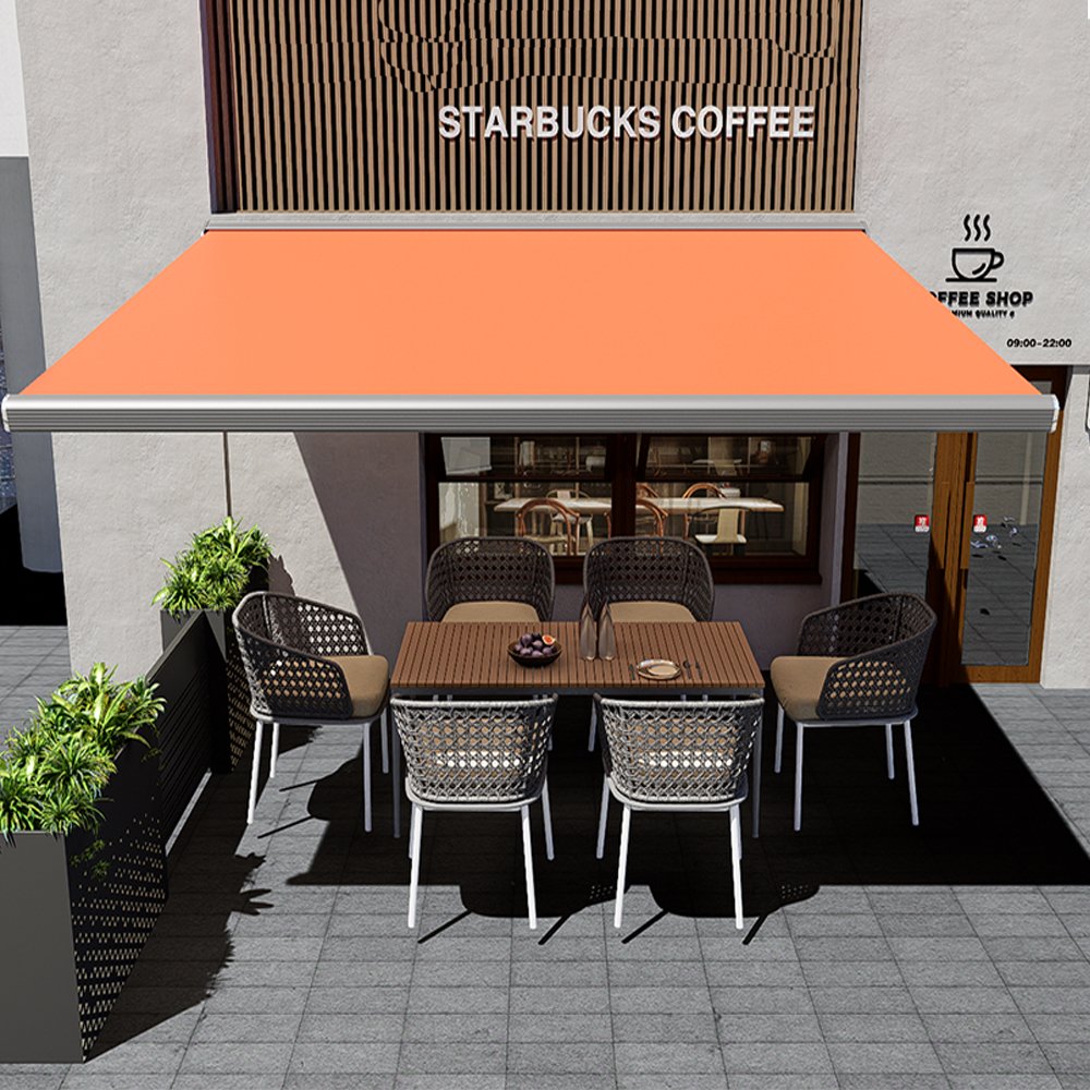 Orange wall-mounted retractable folding arm awning shading an outdoor coffee shop dining area