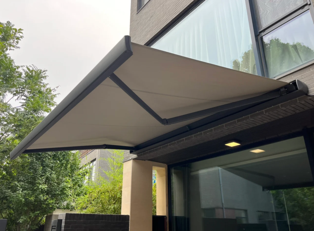 Motorized full cassette retractable awning installed over a residential patio