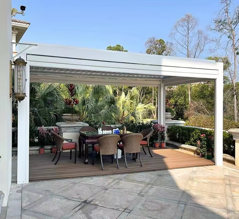 White aluminum louvered pergola covering an outdoor patio dining area
